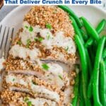 A plate with sliced crispy chicken breast topped with creamy sauce, served alongside steamed green beans. Text overlay reads "11 Crispy Chicken Recipes That Deliver Crunch in Every Bite.