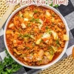 A bowl of cooked cabbage and ground meat in tomato sauce, garnished with parsley, on a textured mat with a fork and napkin beside it. Text above promotes cabbage recipes.
