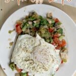 A plate of sautéed vegetables topped with two fried eggs is shown on a wooden surface. Text at the top reads, “15 Breakfast or Dinner Works Better with Simple Egg Recipes.” Perfect for breakfast or dinner!.