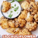 A plate of roasted cauliflower florets with a bowl of white dipping sauce garnished with herbs and a lime wedge; text reads โ16 Cauliflower Recipes That Bring Comfort and Flavor.โ.