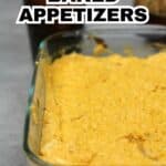 A glass dish filled with party-friendly baked appetizers, topped with gooey cheese, with carrots and celery in the background. Text overlay reads "Baked Appetizers.