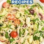 A bowl of orzo salad with cherry tomatoes, cucumbers, red onions, olives, feta cheese, and spinach sits on a light surface. Text reads, "16 Tangy and Salty Flavor Pops in Fresh Feta Recipes.