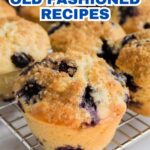Blueberry muffins with sugar topping sit on a cooling rack. Text overlay reads, "19 Comfort and Nostalgia Live in Old Fashioned Recipes.