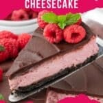 A slice of chocolate raspberry cheesecake with a chocolate crust, topped with fresh raspberries and mint, on a metal spatula.