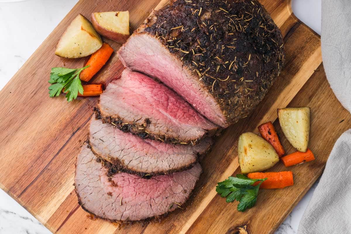 Tender roast beef with carrots and potatoes, effortlessly cooked in your air fryer.
