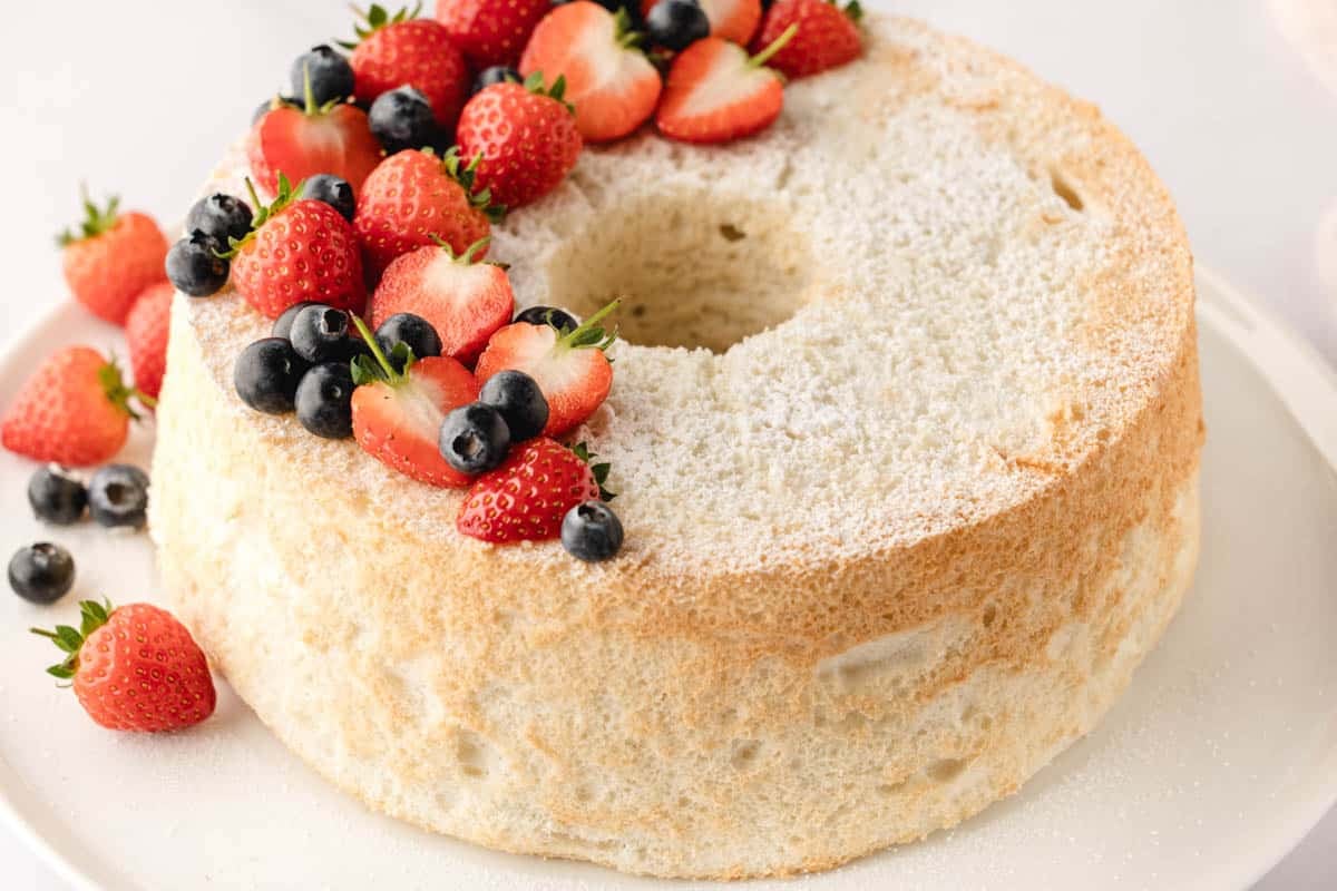 Light angel food cake with whipped cream and fresh fruit—perfect for any occasion.
