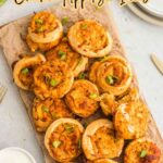 A platter of crispy bitesโsmall, round chicken appetizersโgarnished with chopped green onions and served with a small bowl of dipping sauce. Perfect for party appetizers or fresh chicken appetizer ideas.
