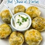 A plate of seven golden-brown baked appetizers with a bowl of creamy dip garnished with chopped chives in the center—perfect savory appetizers for any party.