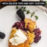 A slice of berry cobbler with whipped cream is served on a white plate with blackberries, next to a dish of the same dessert. Text reads "19 Baked Desserts with Golden Tops and Soft Centers.