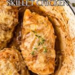 Three pieces of french onion chicken topped with melted cheese and herbs in a skillet, cooked with onions and a brown sauce. Text overlay reads "French Onion Skillet Chicken.