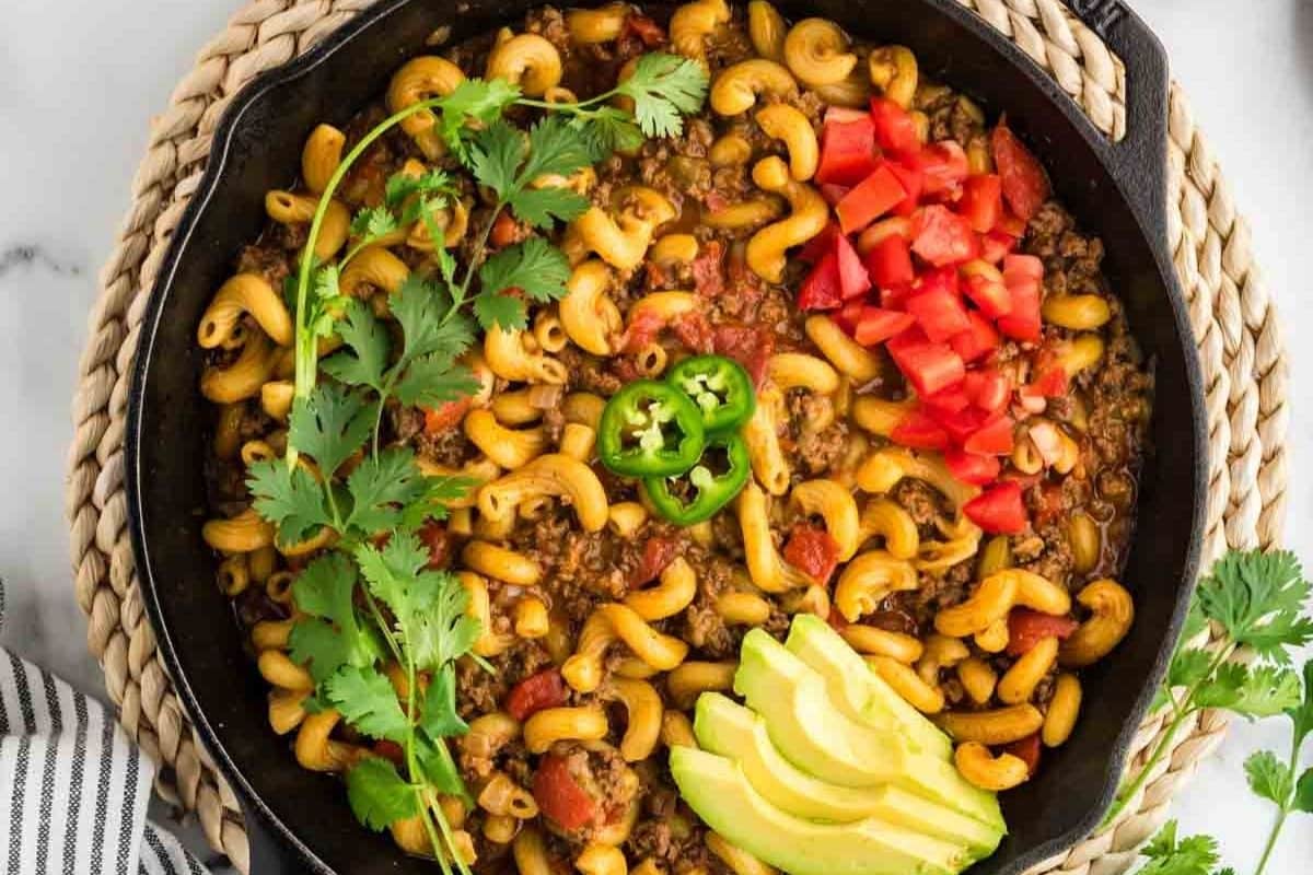 Cheesy taco‑flavored pasta with seasoned beef, melty cheddar, and fresh toppings—perfect for family 