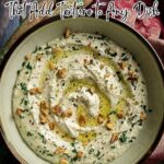 A bowl of creamy dip garnished with chopped walnuts, herbs, and a drizzle of olive oil, displayed with text promoting crunchy walnut recipes.