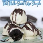 A plate of chocolate truffles coated in white chocolate and drizzled with dark chocolate, with one truffle cut in half, displayed on a light blue plateโperfect for anyone who loves easy no bake desserts.