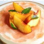 A gluten-free cheesecake with a light texture, topped with peach slices and mint leaves, showcased on a plate alongside text promoting 12 irresistible gluten free desserts.