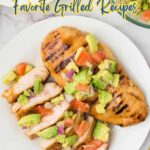 Grilled chicken breast topped with diced tomatoes and avocado, sliced on a white plate with a fork, featuring text about favorite grilled recipes and bold flavor.