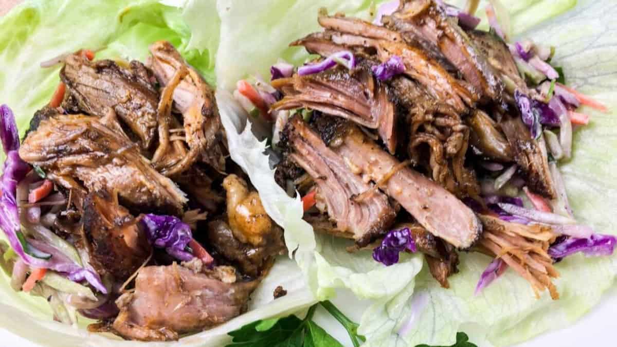 Effortless shredded cooked meat and coleslaw served on large lettuce leaves as wraps—perfect for dinner and inspired by slow cooker pork recipes.