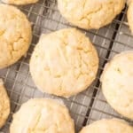 Lime cookies cooling on a metal wire rack, viewed from above.