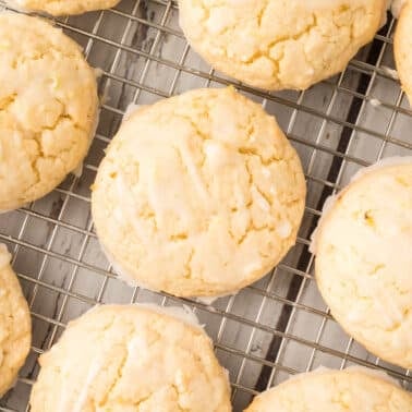 Lime cookies cooling on a metal wire rack, viewed from above.