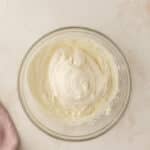 Cream cheese mixture in a clear bowl.