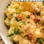 Close-up of Southern potato salad garnished with parsley and paprika in a bowl, with text overlay reading "Southern Potato Salad.