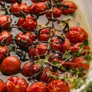 tomato confit garnished with fresh sprigs of thyme.