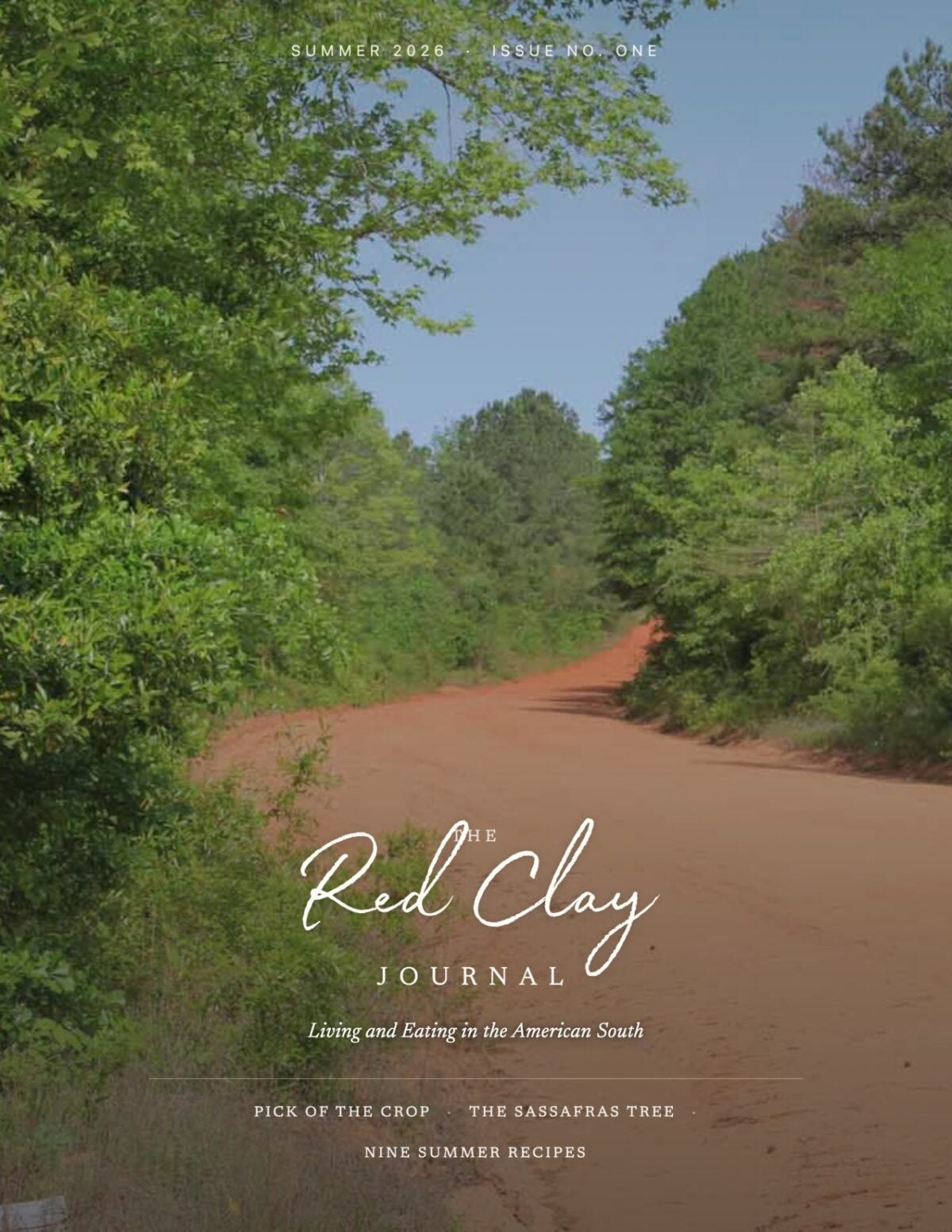 A red clay road runs through a green, wooded area under a blue sky. The magazine title "The Red Clay Journal" appears along with article topics.