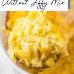 A spoonful of corn pudding being lifted from a baking dish, with the text “Corn Pudding Without Jiffy Mix” at the top.