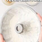 Hands holding a bundt pan coated with flour, with the text “How to grease and flour cake pans” at the top.