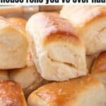 A stack of golden brown Parker house rolls with a glossy finish.